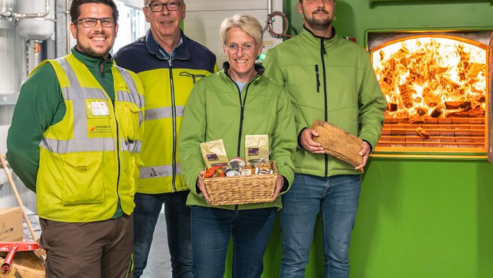 Mitarbeiter von Schmidmeier NaturEnergie und EGST vor Biomassekessel in Saerbeck