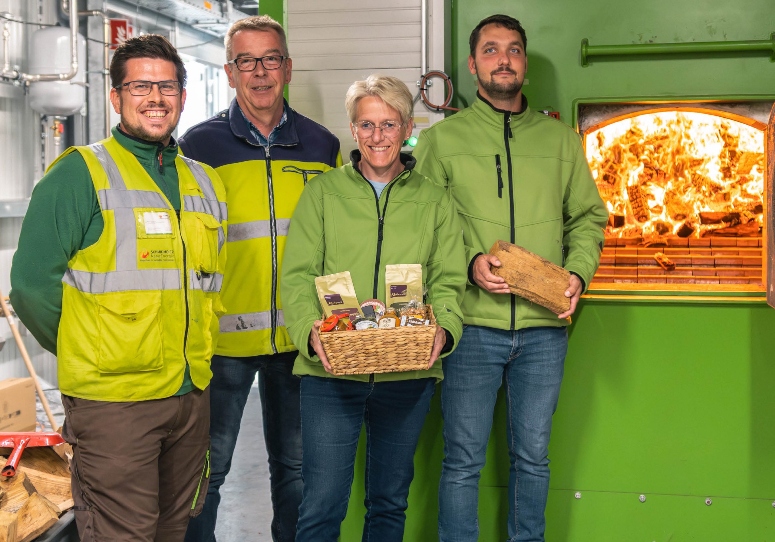 Mitarbeiter von Schmidmeier NaturEnergie und EGST vor Biomassekessel in Saerbeck
