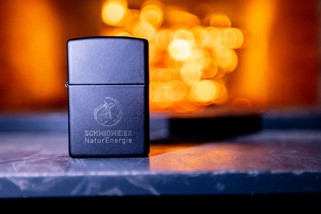 Feuerzug mit Schmidmeier NaturEnergie Logo vor brennendem Kessel